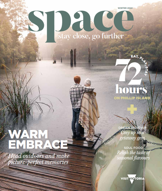 The winter cover of space magazine, featuring a couple rugged up and hugging at the end of a pier overlooking a foggy lake.